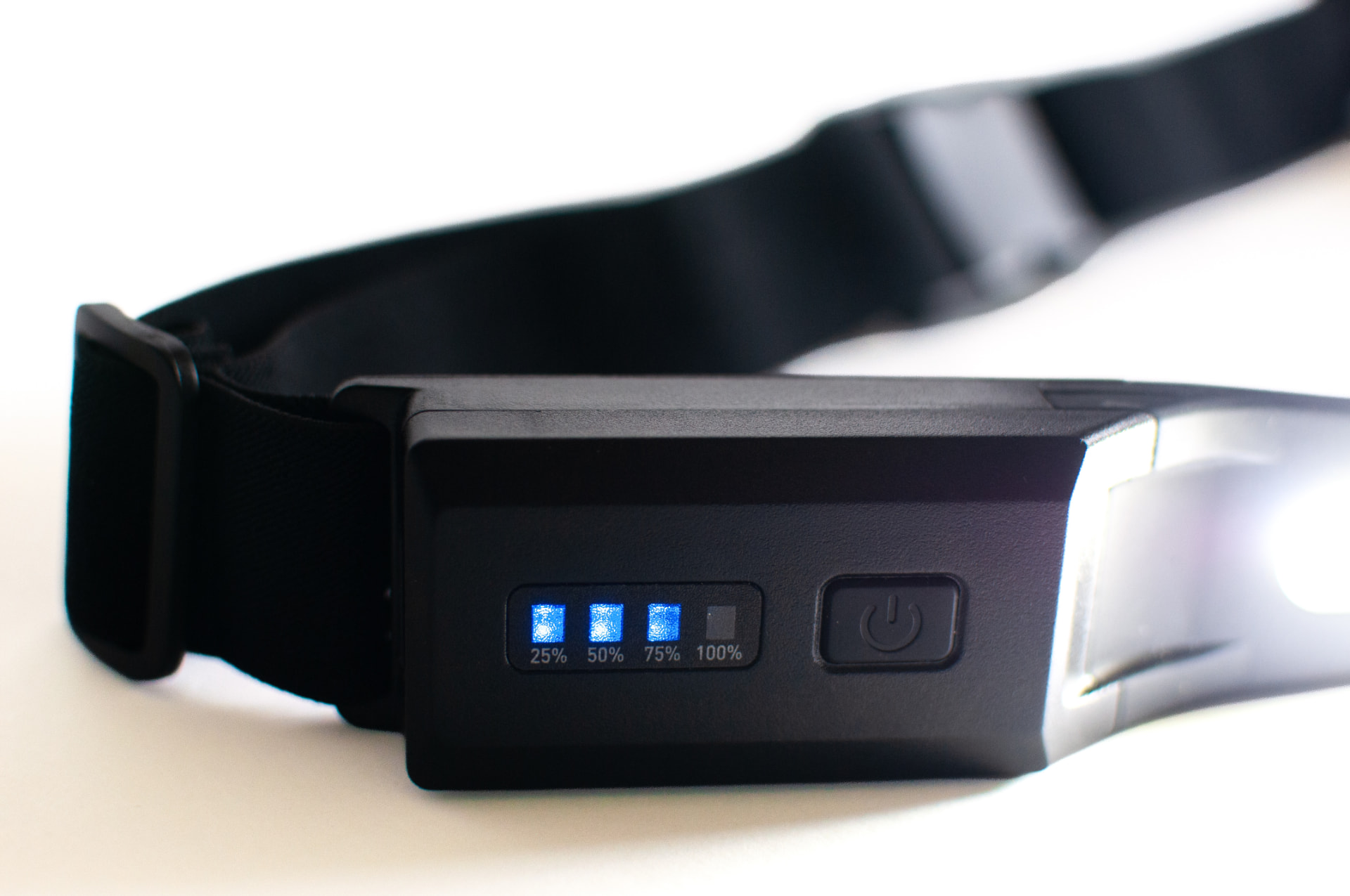 Close-up of the Body StrapLights® control module with battery level lights and the power button